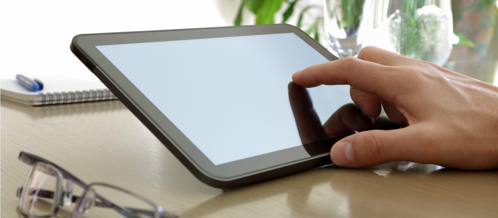 Businessman finger pointing to the screen of a tablet-pc